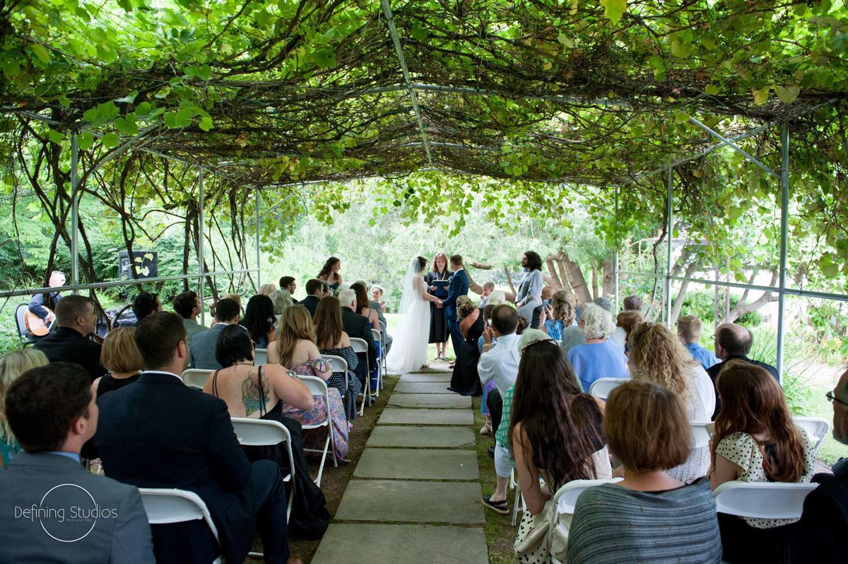 Weddings at Tarrywile Mansion couple-exchange-wedding-vows-in-front-of-guests