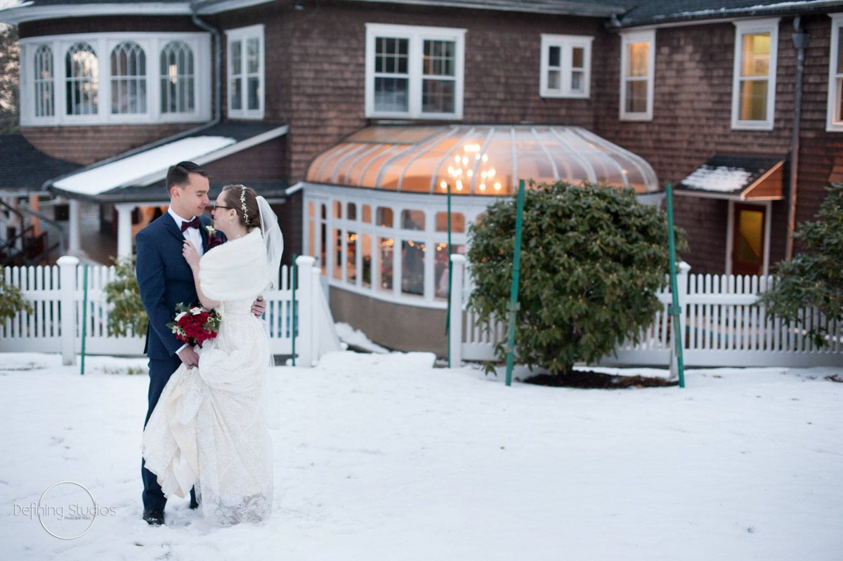 A Winter Wedding Moment christmas-wedding-couple-standing-close-together-with-mansion-as-background