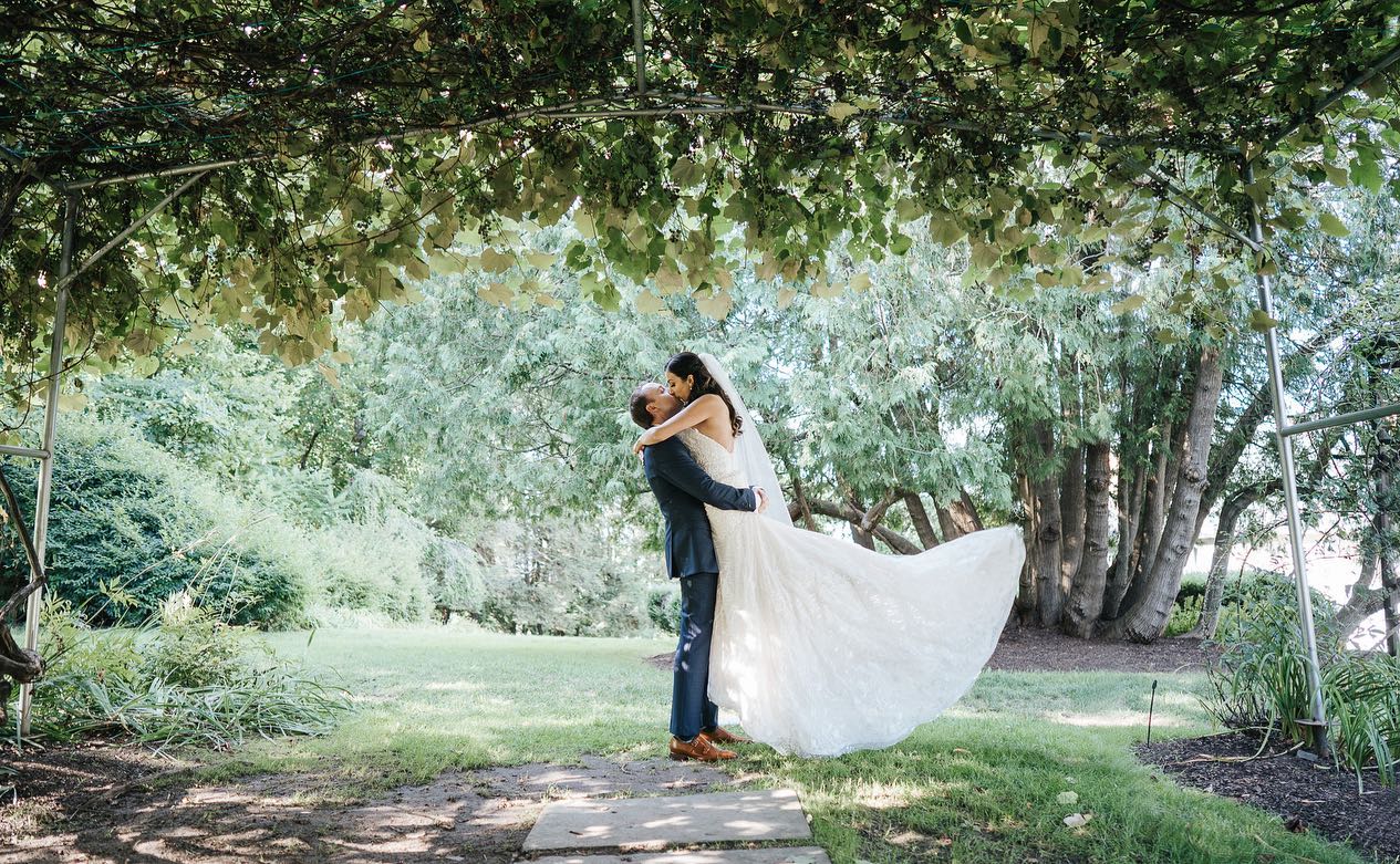 First Loo "Take Two" summer-first-look-groom-lifting-bride-in-kiss-in-grape-arbor
